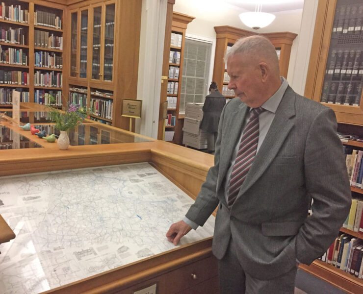 Eugene Scheel looks at his 1990 hand drawn map of Loudoun County inside Thomas Balch Library in downtown Leesburg.