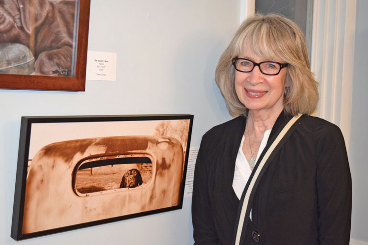 Artist Kathy Kupka with her piece, titled I called shotgun.