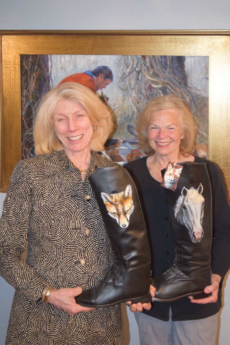 Sandy Danielson with Carole Stadfield holding the work of a dear friend and local artist, Debbie Cadenas.