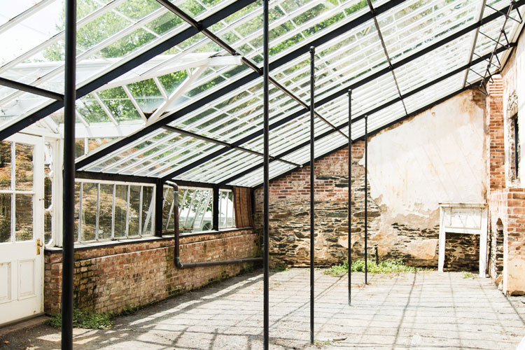 The greenhouse was built by slaves in 1810 from brick and iron, and shows the Carters' interest in modern horticultural practices.