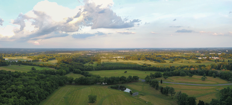 Morven Park's cross country course, horse paddocks, and equestrian complex. The expansive 1,000 acre estate abuts Route 15 near Leesburg, visible in the distance