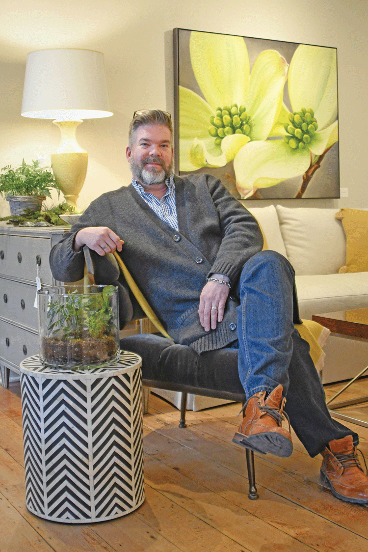 Dan Moore relaxes at Domestic Aspirations, the storefront of his interior design business