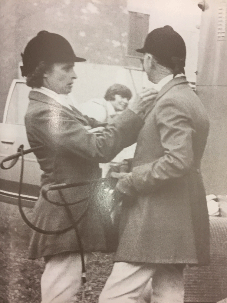 Peggy Poe, Melvin’s wife, helping him get ready for a hunt. Courtesy photo from "Foxhunting with Melvin Poe," by Peter Winants.