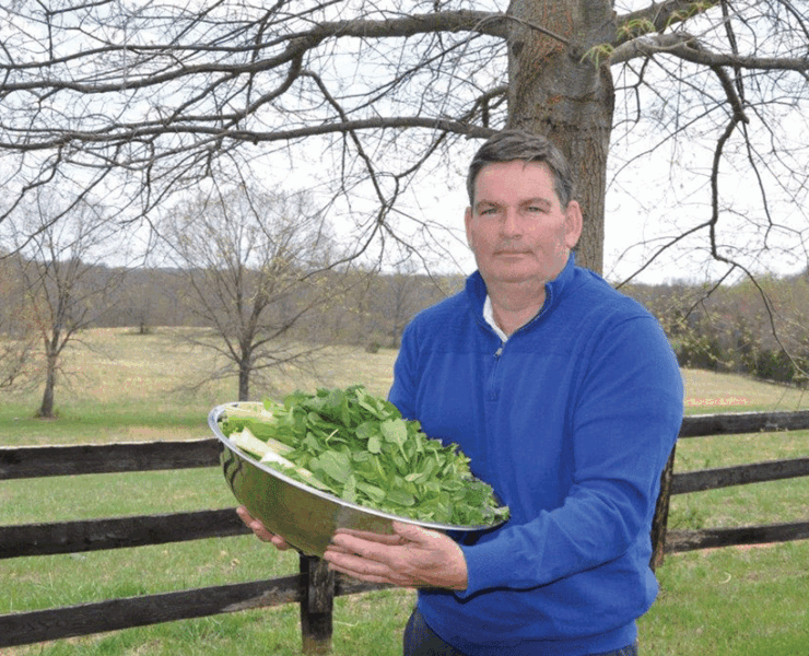 Matt Cahir stands with a bowl of fresh, organic vegetables. Photo courtesy of Middleburg Juice Company