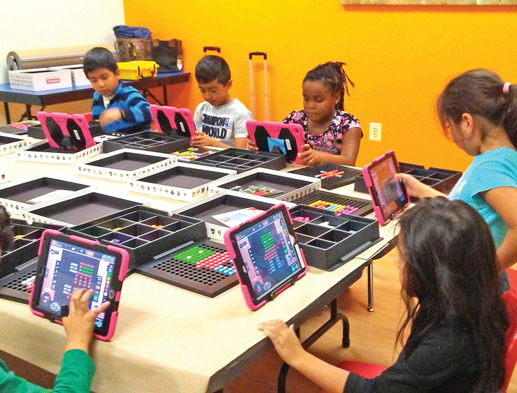 Students participating in a binary coding exercise at INMED’s Opportunity Center in Sterling